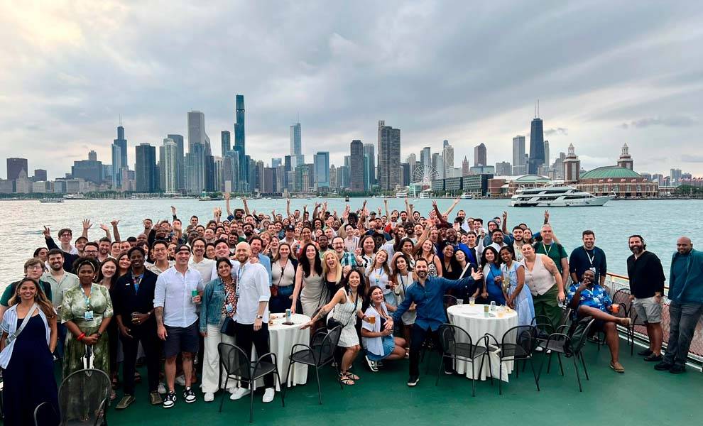 A diverse group of individuals enjoying a boat ride with a vibrant city skyline visible in the background.