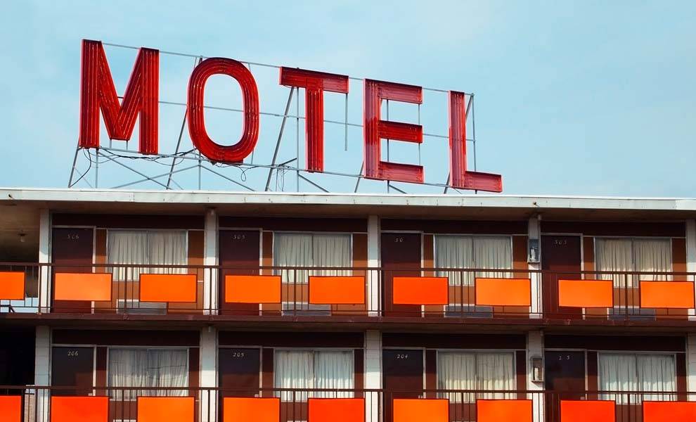 A motel sign prominently displayed atop a building, indicating accommodation services available to travelers.