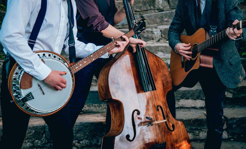 Three men joyfully playing banjo and guitar together, creating a lively musical atmosphere.