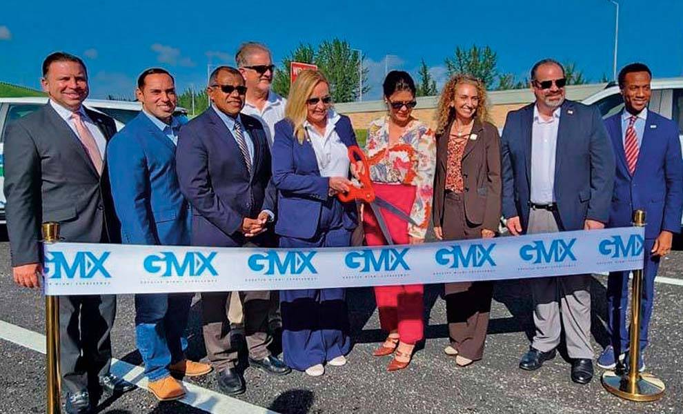 A diverse group of individuals gathered for a ribbon-cutting ceremony, celebrating a new beginning or opening.