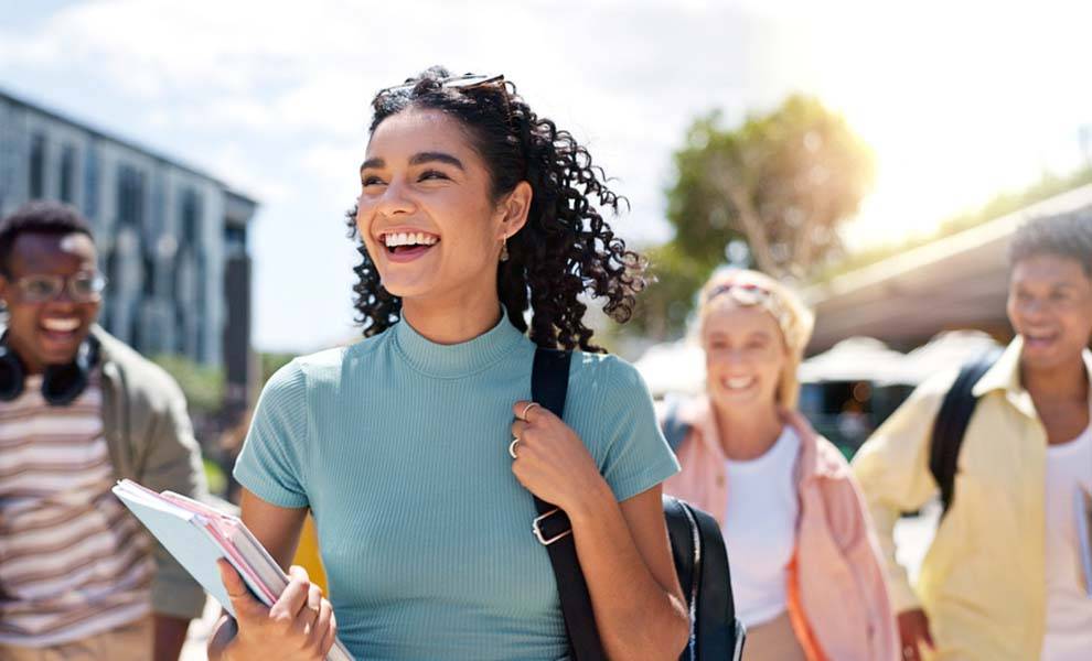 Students smiling walking through the courtyard at Miami Dade College.