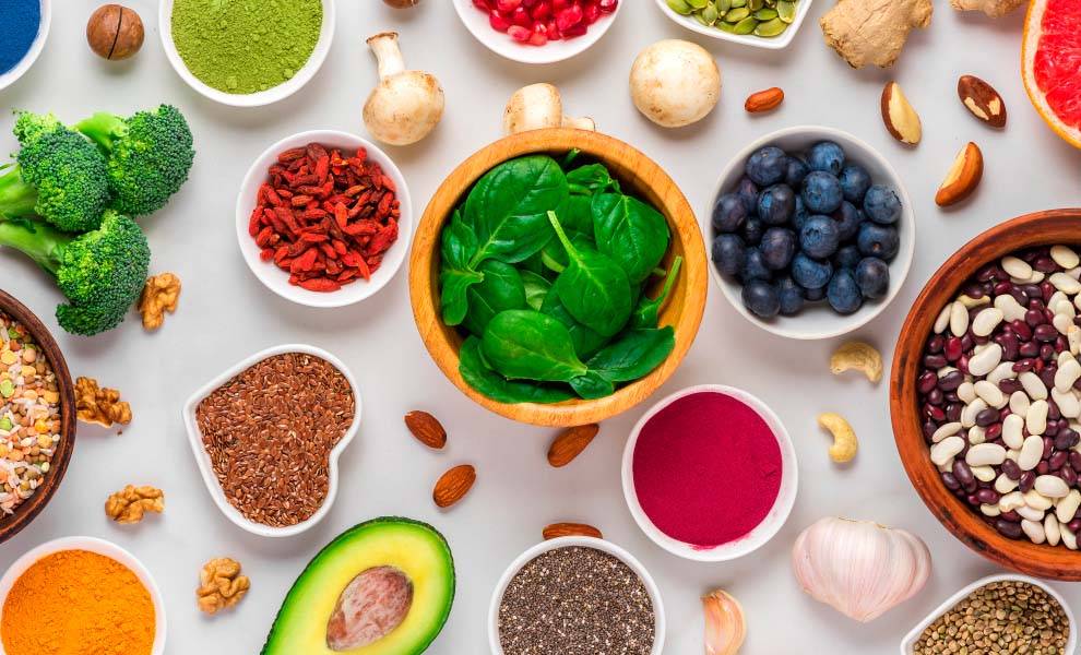A variety of healthy foods displayed in bowls, showcasing colorful fruits, vegetables, and grains for a nutritious meal.