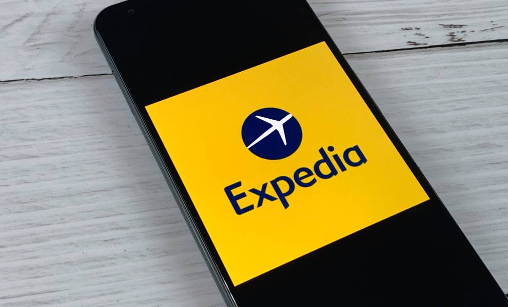 Aplicación de Expedia en un teléfono móvil que está sobre una mesa.