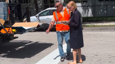Commissioner Eileen Higgins speaks with a contractor about the new 4-way stop.