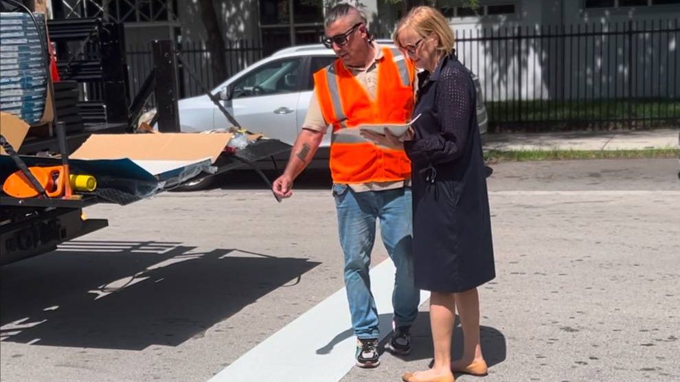 Commissioner Eileen Higgins speaks with a contractor about the new 4-way stop.