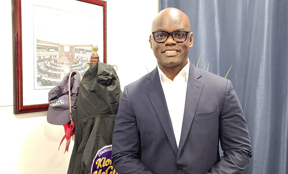 Commissioner Kionne L. McGhee in a white dress shirt and blue jacket.