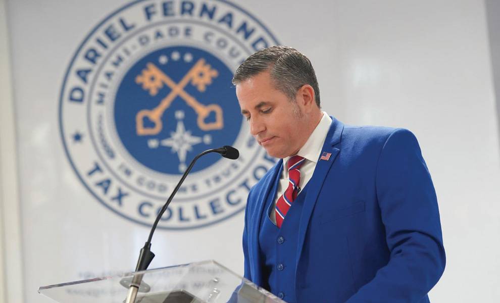 Tax Collector Dariel Fernandez speaking at a podium.