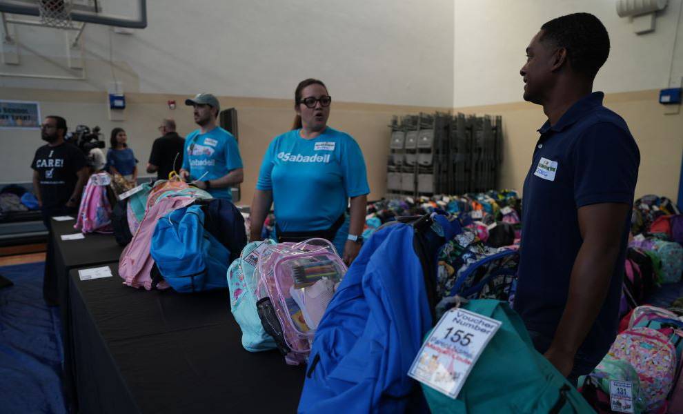 Volunteers at The Caring Place give out school supplies.