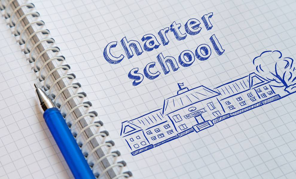 A notebook with an illustration of a charter school in blue ink.