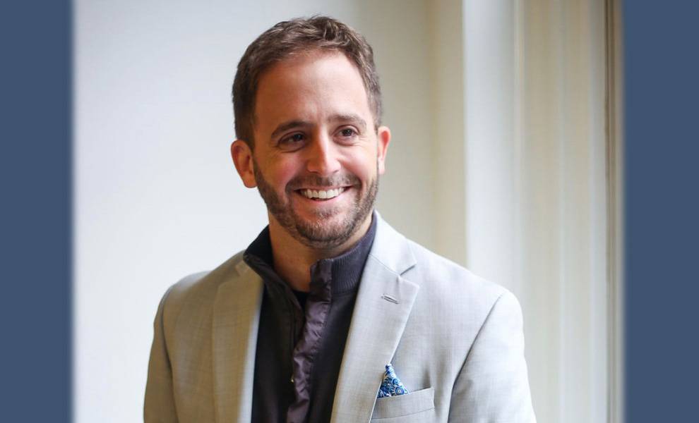 Miami Environmental Activist Andrew Otazo in a gray suit.