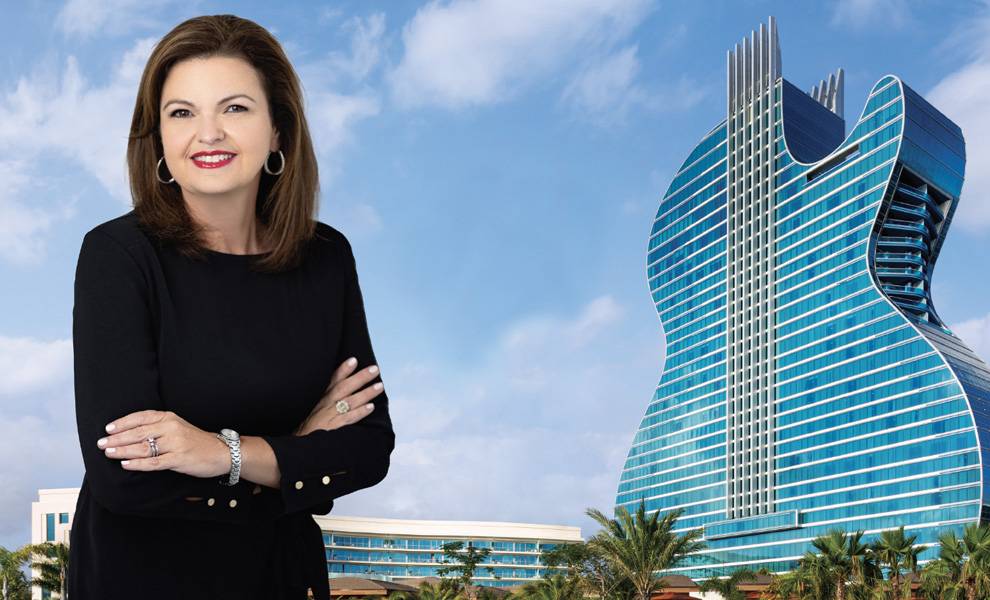 Lourdes Mola from Seminole Hard Rock Hotel and Casino Hollywood smiling in a black dress in front of The Guitar Hotel.