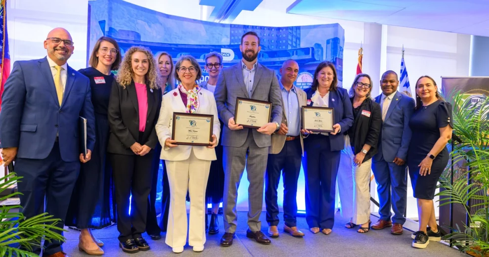 A group of eleven professionals pose together on a stage at a Citizens’ Independent Transportation Trust recognition event in Miami-Dade County.