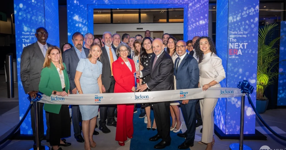 A group of community leaders, healthcare executives, elected officials, and staff members gather for a ribbon-cutting ceremony at Jackson Memorial Hospital.