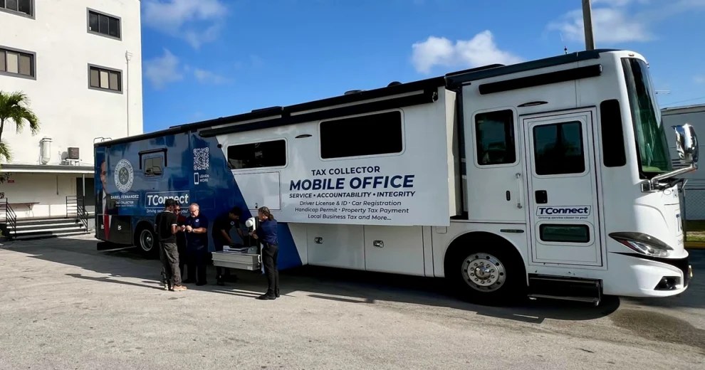 The Miami-Dade Tax Collector's TConnect mobile office is parked outside a building, providing convenient government services to the community.