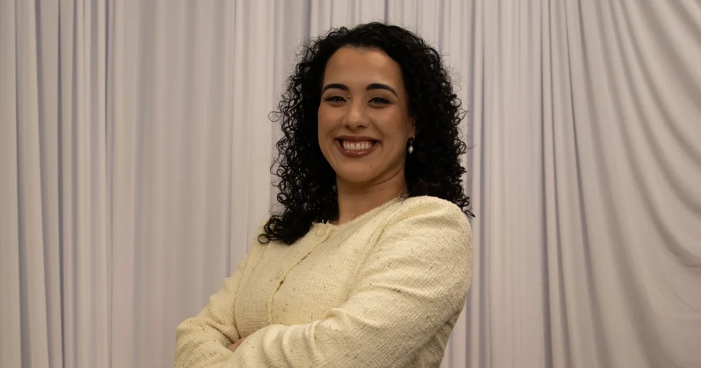 Alexis Calatayud Outlines Plan to Keep Miami-Dade Families From Being Priced Out 1 Florida Senator Alexis Calatayud smiles with her arms crossed, wearing a cream-colored textured jacket and pearl drop earrings in front of light-colored draped curtains.