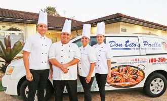 Don Tito and his chefs standing in front of the Don Tito's Paella van.
