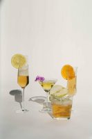 Various drinks made with vanilla liqueur, fruits, and herbs.